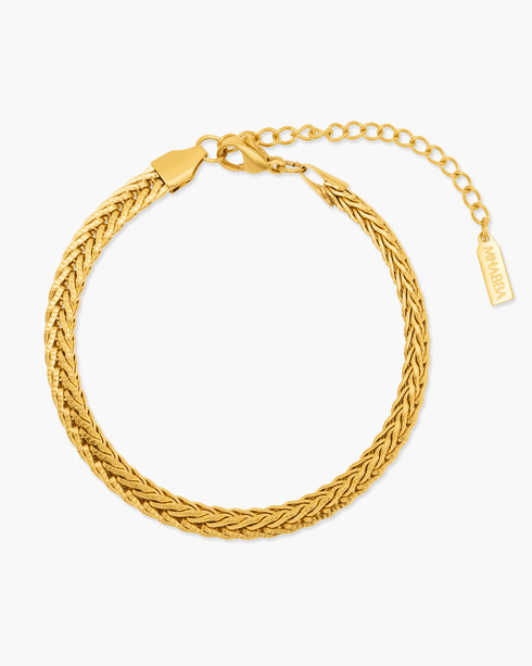 Gold braided bracelet on a white background